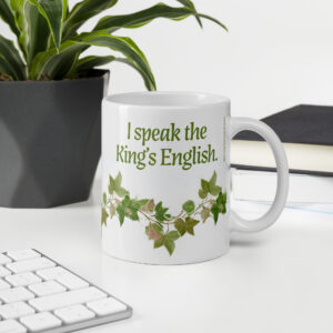 King’s English mug beside books and a keyboard